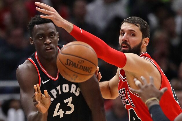 CHICAGO, IL - JANUARY 03:   Pascal Siakam #43 of the Toronto Raptors passes under presuure from Nikola Mirotic #44 of the Chicago Bulls at the United Center on January 3, 2018 in Chicago, Illinois. The Raptors defeated the Bulls 124-115. NOTE TO USER: User expressly acknowledges and agrees that, by downloading and or using this photograph, User is consenting to the terms and conditions of the Getty Images License Agreement. (Photo by Jonathan Daniel/Getty Images)