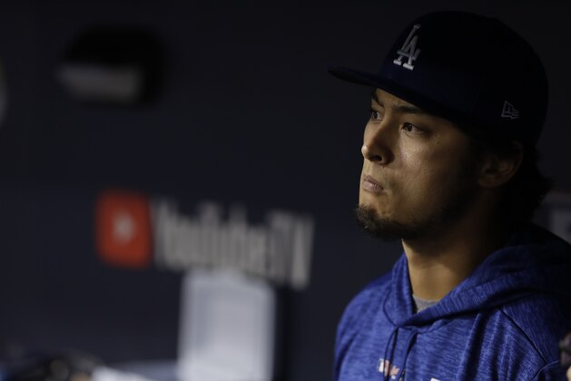 Los Angeles Dodgers' Yu Darvish watches from the dugout during the eighth inning of Game 7 of baseball's World Series against the Houston Astros Wednesday, Nov. 1, 2017, in Los Angeles. (AP Photo/Matt Slocum)