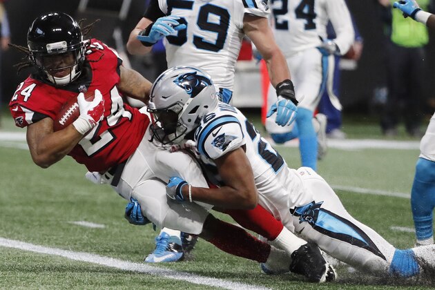 Atlanta Falcons running back Devonta Freeman (24) scores a touchdown as Carolina Panthers cornerback Daryl Worley (26) makes the tackle during the first half of an NFL football game, Sunday, Dec. 31, 2017, in Atlanta. (AP Photo/David Goldman) Atlanta Falcons running back Devonta Freeman (24) scores a touchdown as Carolina Panthers cornerback Daryl Worley (26) makes the tackle during the first half of an NFL football game, Sunday, Dec. 31, 2017, in Atlanta. (AP Photo/David Goldman)