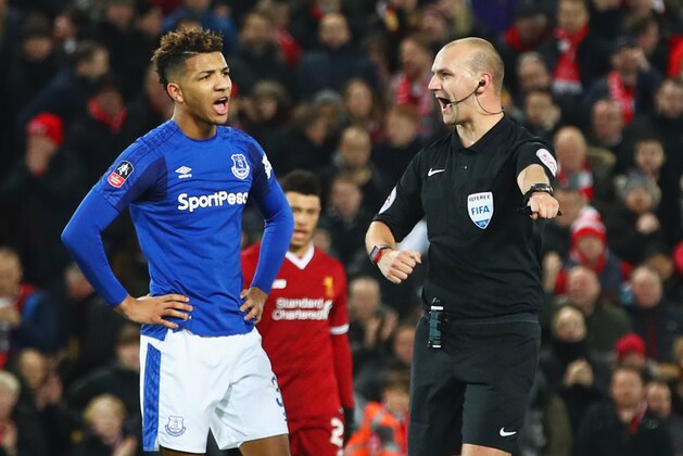LIVERPOOL, ENGLAND - JANUARY 05:  Referee Robert Madley points to the spot as he awards a penalty against Mason Holgate of Everton (L) during the Emirates FA Cup Third Round match between Liverpool and Everton at Anfield on January 5, 2018 in Liverpool, England.  (Photo by Clive Brunskill/Getty Images)