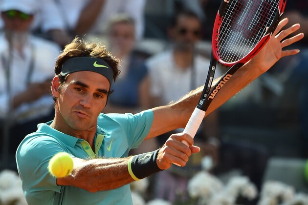 Swiss Roger Federe hits a return to Novak Djokovic of Serbia during the men's final match at the ATP Tennis Open on May 17, 2015 at the Foro Italico in Rome.       AFP PHOTO / GABRIEL BOUYS        (Photo credit should read GABRIEL BOUYS/AFP/Getty Images)