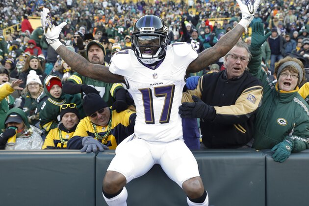 Baltimore Ravens' Mike Wallace celebrates in the stands at Lambeau Field after catching a touchdown pass during the second half of an NFL football game against the Green Bay Packers Sunday, Nov. 19, 2017, in Green Bay, Wis. (AP Photo/Jeffrey Phelps)