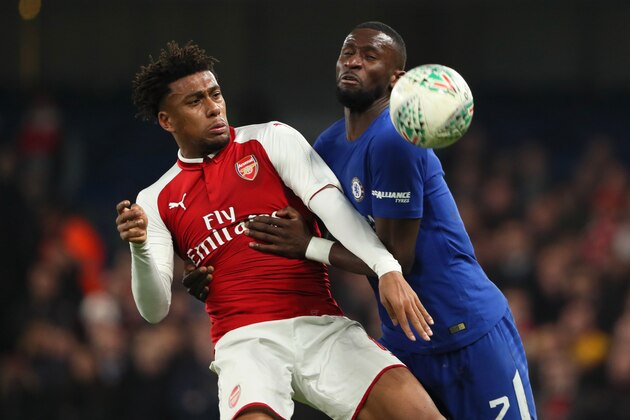 LONDON, ENGLAND - JANUARY 10:  Alex Iwobi of Arsenal competes with Antonio Rudiger of Chelsea during the Carabao Cup Semi-Final first leg match between Chelsea and Arsenal at Stamford Bridge on January 10, 2018 in London, England.  (Photo by Matthew Ashton - AMA/Getty Images)