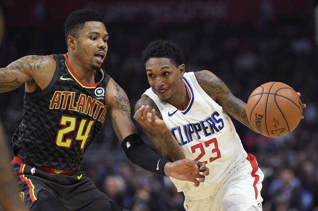 Los Angeles Clippers guard Lou Williams, right, drives by Atlanta Hawks guard Kent Bazemore during the second half of a basketball game, Monday, Jan. 8, 2018, in Los Angeles. The Clippers won 108-107. (AP Photo/Mark J. Terrill)