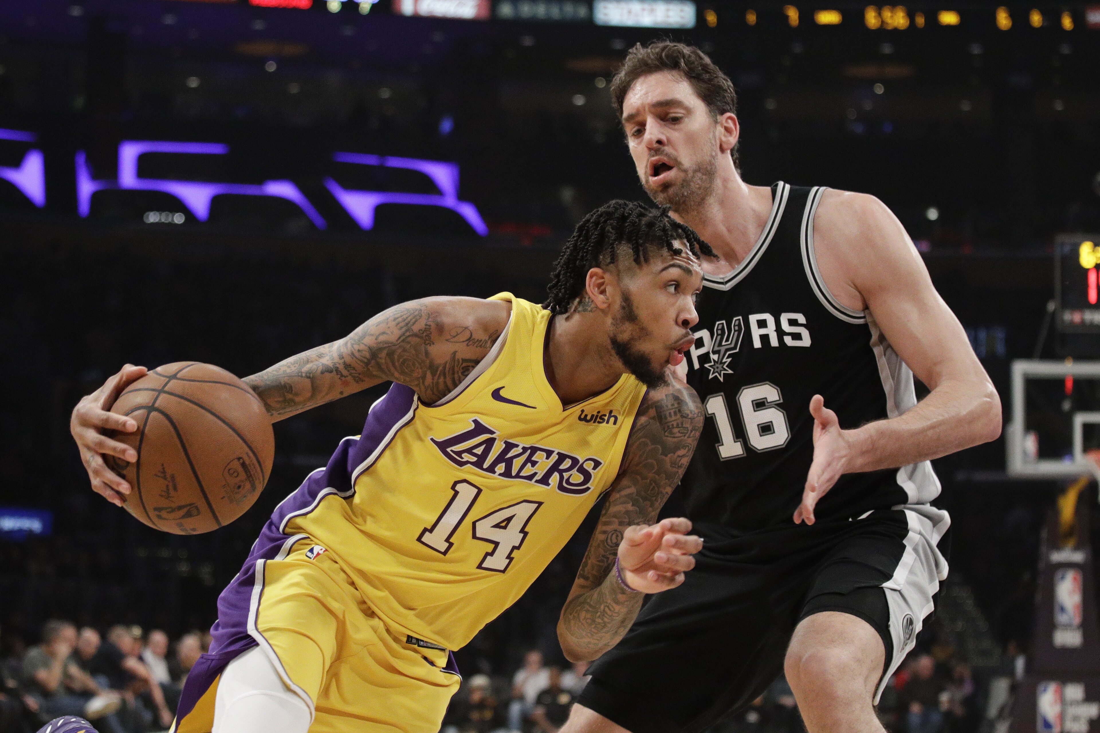 Los Angeles Lakers' Brandon Ingram, left, drives past San Antonio Spurs' Pau Gasol, of Spain, during the first half of an NBA basketball game Thursday, Jan. 11, 2018, in Los Angeles. (AP Photo/Jae C. Hong)