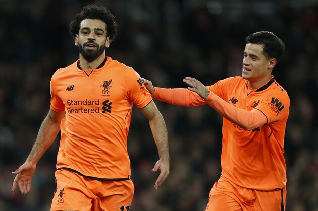 Liverpool's Egyptian midfielder Mohamed Salah (L) celebrates scoring the second goal with Liverpool's Brazilian midfielder Philippe Coutinho during the English Premier League football match between Arsenal and Liverpool at the Emirates Stadium in London on December 22, 2017.  / AFP PHOTO / Ian KINGTON / RESTRICTED TO EDITORIAL USE. No use with unauthorized audio, video, data, fixture lists, club/league logos or 'live' services. Online in-match use limited to 75 images, no video emulation. No use in betting, games or single club/league/player publications.  /         (Photo credit should read IAN KINGTON/AFP/Getty Images)