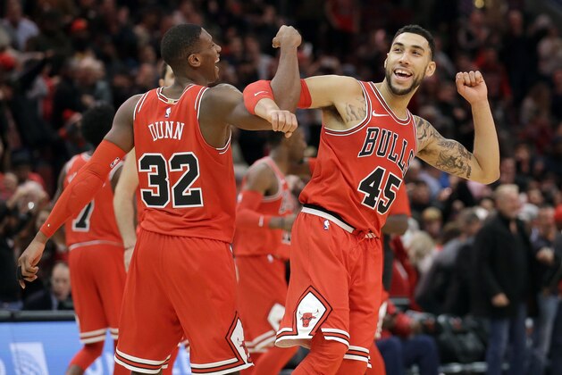 Chicago Bulls guard Kris Dunn, left, celebrates with Denzel Valentine after the Chicago Bulls defeated the Utah Jazz 103-100 in an NBA basketball game Wednesday, Dec. 13, 2017, in Chicago. (AP Photo/Nam Y. Huh)