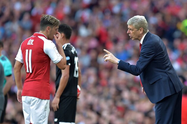 Arsenal's French manager Arsene Wenger (R) interacts with Arsenal's German midfielder Mesut Ozil during the pre-season friendly football match between Arsenal and Sevilla at The Emirates Stadium in north London on July 30, 2017, the game is one of four matches played over two days for the Emirates Cup. / AFP PHOTO / OLLY GREENWOOD        (Photo credit should read OLLY GREENWOOD/AFP/Getty Images)