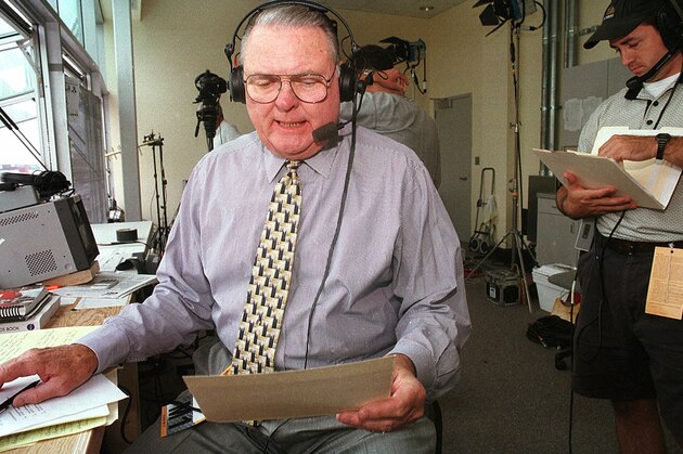 ABC television sports commentator Keith Jackson reads through a checklist prior to the Nebraska-California football game Saturday, Sept. 11, 1999 in Lincoln, Neb. Jackson came out of retirement to give the play-by-play for the PAC 10 colleges over the next three years. (AP Photo/S.E. McKee)