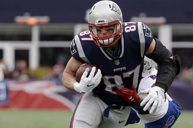 New England Patriots tight end Rob Gronkowski, front, runs from Buffalo Bills defensive back Leonard Johnson after catching a pass during the first half of an NFL football game, Sunday, Dec. 24, 2017, in Foxborough, Mass. (AP Photo/Steven Senne)