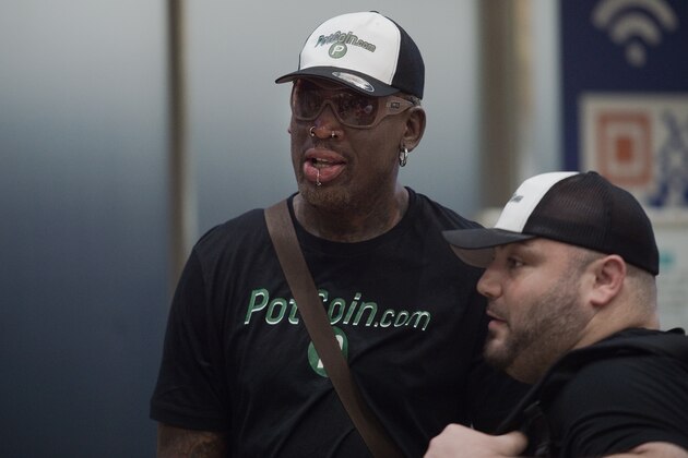 Former NBA basketball player Dennis Rodman (C) of the US walks out from the arrival gate returning from his trip to North Korea at Beijing's international airport on June 17, 2017. / AFP PHOTO / NICOLAS ASFOURI        (Photo credit should read NICOLAS ASFOURI/AFP/Getty Images)