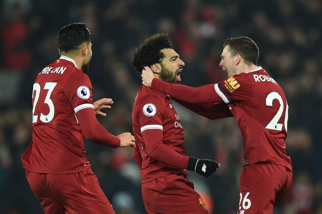 Liverpool's Egyptian midfielder Mohamed Salah (C) celebrates scoring their fourth goal to make the score 4-1 with team-mates Liverpool's Scottish defender Andrew Robertson (R) and Liverpool's German midfielder Emre Can (L) during the English Premier League football match between Liverpool and Manchester City at Anfield in Liverpool, north west England on January 14, 2018. / AFP PHOTO / Oli SCARFF / RESTRICTED TO EDITORIAL USE. No use with unauthorized audio, video, data, fixture lists, club/league logos or 'live' services. Online in-match use limited to 75 images, no video emulation. No use in betting, games or single club/league/player publications.  /         (Photo credit should read OLI SCARFF/AFP/Getty Images)