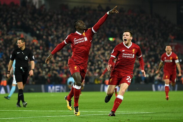 LIVERPOOL, ENGLAND - JANUARY 14: Sadio Mane of Liverpool celebrates with team mate Andy Robertson after scoring the third Liverpool goal during the Premier League match between Liverpool and Manchester City at Anfield on January 14, 2018 in Liverpool, England. (Photo by Shaun Botterill/Getty Images) LIVERPOOL, ENGLAND - JANUARY 14: Sadio Mane of Liverpool celebrates with team mate Andy Robertson after scoring the third Liverpool goal during the Premier League match between Liverpool and Manchester City at Anfield on January 14, 2018 in Liverpool, England. (Photo by Shaun Botterill/Getty Images)