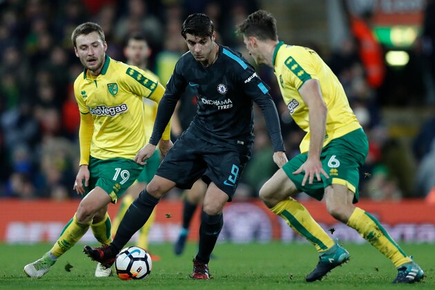 Chelsea's Spanish striker Alvaro Morata (C) takes on Norwich City's German defender Christoph Zimmermann (R) Norwich City's German midfielder Tom Trybull (L) during the English FA Cup third round football match between Norwich City and Chelsea at Carrow Road in Norwich, north east England on January 6, 2018. / AFP PHOTO / Adrian DENNIS / RESTRICTED TO EDITORIAL USE. No use with unauthorized audio, video, data, fixture lists, club/league logos or 'live' services. Online in-match use limited to 75 images, no video emulation. No use in betting, games or single club/league/player publications.  /         (Photo credit should read ADRIAN DENNIS/AFP/Getty Images)