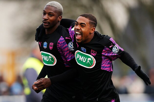 Bordeaux's Senegalese midfielder Younousse Sankhare (L) is congratulated by Bordeaux's forward Malcom (R) after scoring a goal during the French Cup football match between Granville (USG) and Bordeaux (USG) on January 7, 2018 at the Louis Dior Stadium in Granville, northwesthern France. / AFP PHOTO / CHARLY TRIBALLEAU        (Photo credit should read CHARLY TRIBALLEAU/AFP/Getty Images)