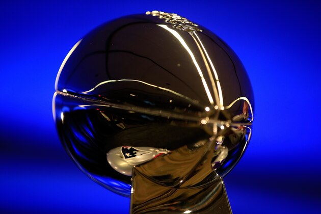 PHOENIX, AZ - FEBRUARY 02:  A detail of the New England Patriots logo reflected in the Vince Lombardi trophy during a press conference with New England Patriots head coach Bill Belichick and Chevrolet Super Bowl  XLIX MVP Tom Brady following the Patriots Super Bowl win over the Seattle Seahawks on February 2, 2015 in Phoenix, Arizona.  (Photo by Jamie Squire/Getty Images)