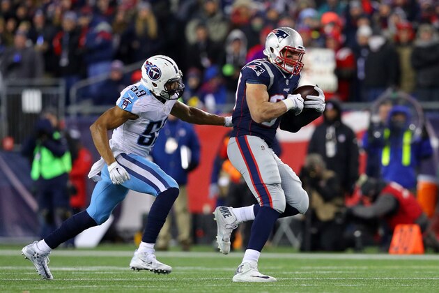 FOXBOROUGH, MA - JANUARY 13:  Rob Gronkowski #87 of the New England Patriots catches a pass as he is defended  by Wesley Woodward #59 of the Tennessee Titans during the fourth quarter  in the AFC Divisional Playoff game at Gillette Stadium on January 13, 2018 in Foxborough, Massachusetts.  (Photo by Maddie Meyer/Getty Images)