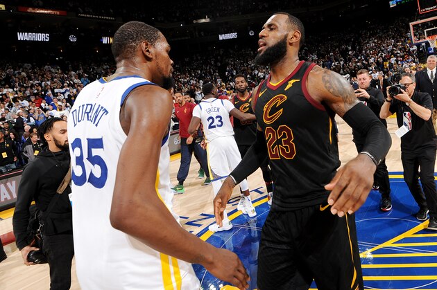 OAKLAND, CA - DECEMBER 25: Kevin Durant #35 of the Golden State Warriors exchanges a hug with LeBron James #23 of the Cleveland Cavaliers after the game between the two teams on December 25, 2017 at ORACLE Arena in Oakland, California. NOTE TO USER: User expressly acknowledges and agrees that, by downloading and or using this photograph, user is consenting to the terms and conditions of Getty Images License Agreement. Mandatory Copyright Notice: Copyright 2017 NBAE (Photo by Noah Graham/NBAE via Getty Images)