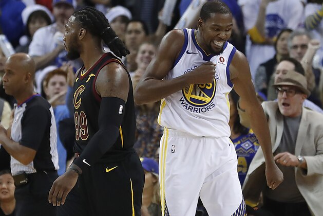 Golden State Warriors forward Kevin Durant (35) reacts after blocking a shot by Cleveland Cavaliers forward LeBron James during the second half of an NBA basketball game in Oakland, Calif., Monday, Dec. 25, 2017. The Warriors won 99-92. (AP Photo/Tony Avelar)
