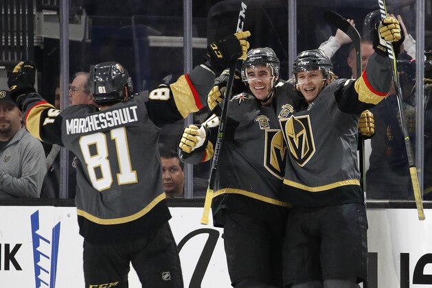Vegas Golden Knights right wing Reilly Smith, center, celebrates after center William Karlsson, right, scored against the Toronto Maple Leafs during the first period of an NHL hockey game Sunday, Dec. 31, 2017, in Las Vegas. (AP Photo/John Locher)