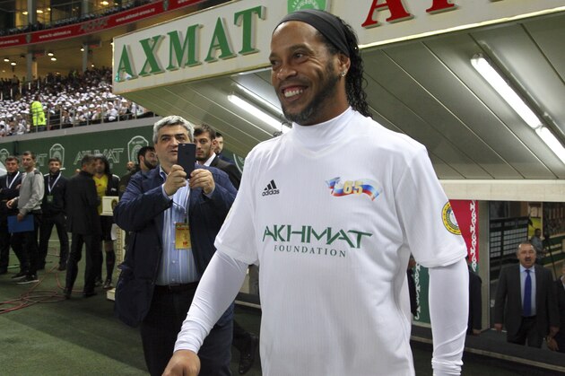 Brazilian soccer star and former FC Barcelona player Ronaldinho, prepares to play in the Chechnya's regional leader Ramzan Kadyrov's team against the Italian former players team in Grozny, Russia, Saturday, Oct. 7, 2017. The Chechen leader, who is fond of sports, particularly soccer and martial arts, enjoys bringing foreign sports stars and other celebrities to Grozny. (AP Photo/Musa Sadulayev)