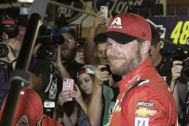 CORRECTS BYLINE TO DARRYL GRAHAM NOT TERRY RENNA Dale Earnhardt Jr. is surrounded upon getting out of his car after a NASCAR Cup Series auto race at Homestead-Miami Speedway in Homestead, Fla., Sunday, Nov. 19, 2017. Earnhardt is retiring from full-time racing. (AP Photo/Darryl Graham)