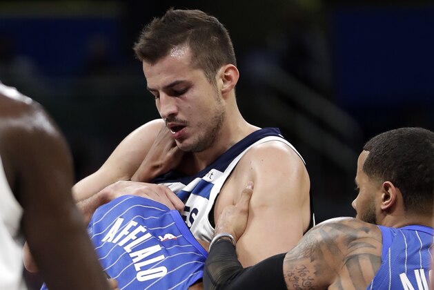 Orlando Magic's Arron Afflalo, left, gets into a fight with Minnesota Timberwolves' Nemanja Bjelica, center, as D.J. Augustin, right, comes in to help break it up during the first half of an NBA basketball game, Tuesday, Jan. 16, 2018, in Orlando, Fla. Afflalo and Bjelica were ejected from the game. (AP Photo/John Raoux)