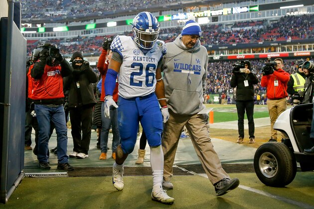 NASHVILLE, TN - DECEMBER 29:  Benny Snell Jr. #26 of the Kentucky Wildcats is escorted off the field after being ejected for contact with an official against the Northwestern Wildcats during the Music City Bowl at Nissan Stadium on December 29, 2017 in Nashville, Tennessee.  (Photo by Michael Reaves/Getty Images)