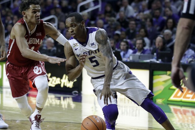 Kansas State guard Barry Brown (5) drives on Oklahoma guard Trae Young (11) during the second half of an NCAA college basketball game in Manhattan, Kan., Tuesday, Jan. 16, 2018. (AP Photo/Orlin Wagner)