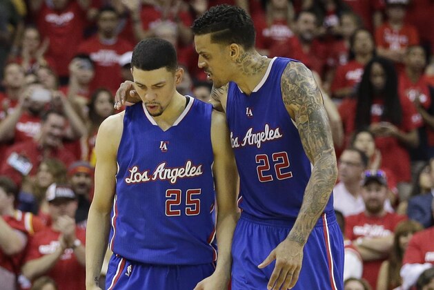 Los Angeles Clippers' Austin Rivers (25) and Matt Barnes (22) walk off the court following Game 2 in a second-round NBA basketball playoff series against the Houston Rockets, Wednesday, May 6, 2015, in Houston. Houston won 115-109. (AP Photo/David J. Phillip)