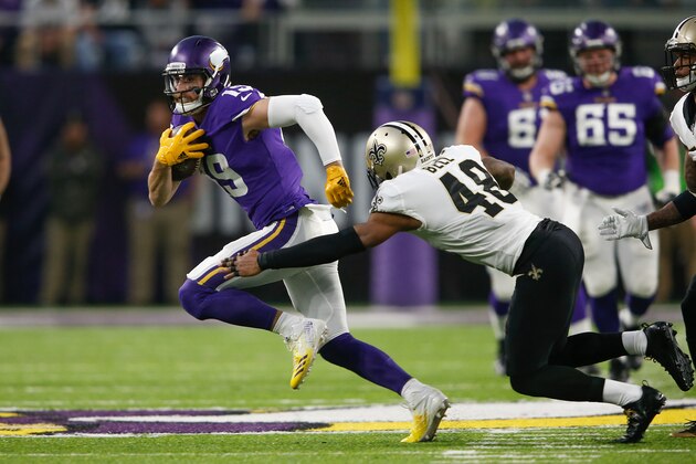 MINNEAPOLIS, MN - JANUARY 14:  Adam Thielen #19 of the Minnesota Vikings breaks a tackle from Vonn Bell #48 of the New Orleans Saints during the first half of the NFC Divisional Playoff game at U.S. Bank Stadium on January 14, 2018 in Minneapolis, Minnesota.  (Photo by Jamie Squire/Getty Images)