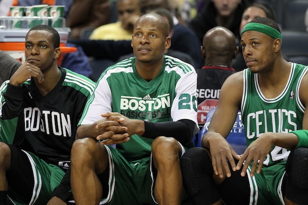 Boston Celtics point guard Rajon Rondo (9), guard Ray Allen (20) and forward Paul Pierce (34) watch the final minutes tick away from the bench in the second half of an NBA basketball game in Charlotte, NC, Saturday, Dec. 11, 2010. The Boston Celtics won 93-62. (AP Photo/Bob Leverone)