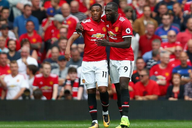 MANCHESTER, ENGLAND - AUGUST 13: Anthony Martial of Manchester United celebrates scoring his sides third goal with Romelu Lukaku of Manchester United during the Premier League match between Manchester United and West Ham United at Old Trafford on August 13, 2017 in Manchester, England.  (Photo by Dan Istitene/Getty Images)