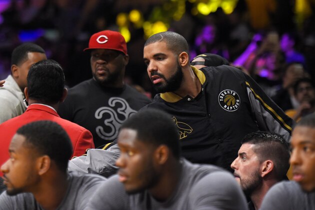 Rapper Drake, right, says goodbye to members of the Toronto Raptors during an NBA basketball game between the Raptors and the Los Angeles Lakers, Friday, Nov. 20, 2015, in Los Angeles. The Raptors won 102-91. (AP Photo/Mark J. Terrill)