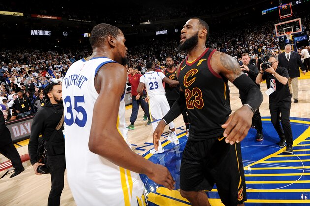 OAKLAND, CA - DECEMBER 25: Kevin Durant #35 of the Golden State Warriors exchanges a hug with LeBron James #23 of the Cleveland Cavaliers after the game between the two teams on December 25, 2017 at ORACLE Arena in Oakland, California. NOTE TO USER: User expressly acknowledges and agrees that, by downloading and or using this photograph, user is consenting to the terms and conditions of Getty Images License Agreement. Mandatory Copyright Notice: Copyright 2017 NBAE (Photo by Noah Graham/NBAE via Getty Images)