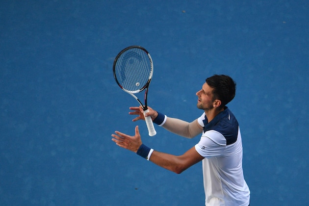 Serbia's Novak Djokovic celebrates beating France's Gael Monfils in their men's singles second round match on day four of the Australian Open tennis tournament in Melbourne on January 18, 2018. / AFP PHOTO / SAEED KHAN / -- IMAGE RESTRICTED TO EDITORIAL USE - STRICTLY NO COMMERCIAL USE --        (Photo credit should read SAEED KHAN/AFP/Getty Images)