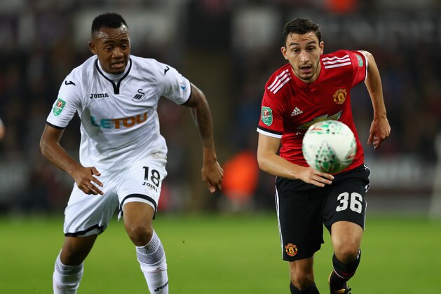SWANSEA, WALES - OCTOBER 24:  Jordan Ayew of Swansea City and Matteo Darmian of Manchester United in action during the Carabao Cup Fourth Round match between Swansea City and Manchester United at Liberty Stadium on October 24, 2017 in Swansea, Wales.  (Photo by Michael Steele/Getty Images)