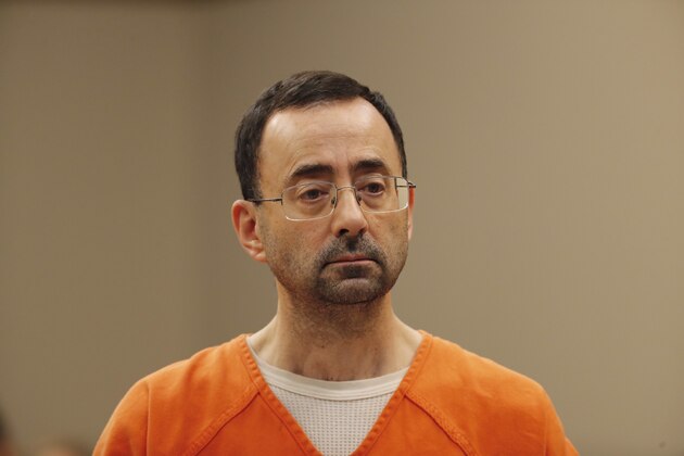 FILE - In this Nov. 22, 2017, file photo, Dr. Larry Nassar, appears in court for a plea hearing in Lansing, Mich. Nassar, an elite Michigan sports doctor who possessed child pornography and assaulted gymnasts, was sentenced Thursday, Dec. 7, 2017,  to 60 years in federal prison in one of three criminal cases that ensure he will never be free again. (AP Photo/Paul Sancya, File)
