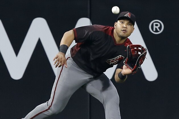 Arizona Diamondbacks left fielder Yasmany Tomas waits to catch a fly ball hit by San Diego Padres' Hunter Renfroe during the first inning of a baseball game in San Diego, Saturday, May 20, 2017. (AP Photo/Alex Gallardo)