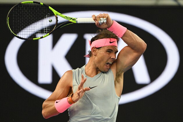 Spain's Rafael Nadal hits a return against Bosnia's Damir Dzumhur during their men's singles third round match on day five of the Australian Open tennis tournament in Melbourne on January 19, 2018. / AFP PHOTO / SAEED KHAN / -- IMAGE RESTRICTED TO EDITORIAL USE - STRICTLY NO COMMERCIAL USE --        (Photo credit should read SAEED KHAN/AFP/Getty Images)