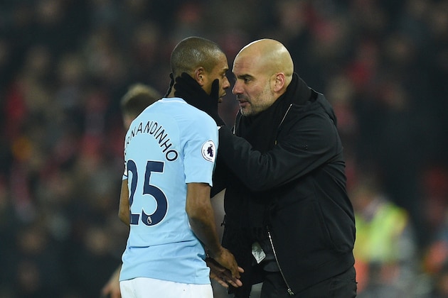 Manchester City's Spanish manager Pep Guardiola (R) talks with Manchester City's Brazilian midfielder Fernandinho (L) on the touchliner during the English Premier League football match between Liverpool and Manchester City at Anfield in Liverpool, north west England on January 14, 2018. / AFP PHOTO / Oli SCARFF / RESTRICTED TO EDITORIAL USE. No use with unauthorized audio, video, data, fixture lists, club/league logos or 'live' services. Online in-match use limited to 75 images, no video emulation. No use in betting, games or single club/league/player publications.  /         (Photo credit should read OLI SCARFF/AFP/Getty Images)