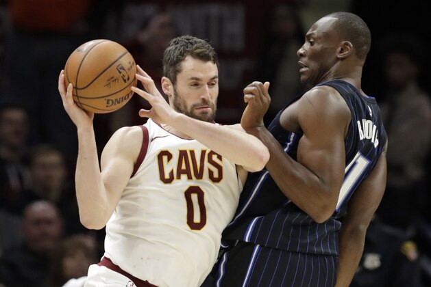 Cleveland Cavaliers' Kevin Love (0) drives past Orlando Magic's Jonathon Simmons (17) during the second half of an NBA basketball game Thursday, Jan. 18, 2018, in Cleveland. The Cavaliers won 104-103. (AP Photo/Tony Dejak)