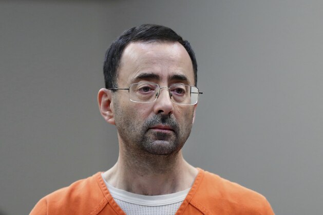 In this Nov. 22, 2017 file photo, Dr. Larry Nassar, 54, appears in court for a plea hearing in Lansing, Mich. Nasser, a sports doctor accused of molesting girls while working for USA Gymnastics and Michigan State University pleaded, guilty to multiple charges of sexual assault and will face at least 25 years in prison.(AP Photo/Paul Sancya)