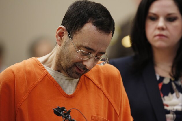 Former Michigan State University and USA Gymnastics doctor Larry Nassar (L) reacts to defense attorney Shannon Smith (R) reading the charges he pled to in Ingham County Circuit Court on November 22, 2017 in Lansing, Michigan.
Former USA Gymnastics team doctor Lawrence (Larry) Nassar, accused of molesting dozens of female athletes over several decades, on Wednesday pleaded guilty to multiple counts of criminal sexual conduct. Nassar -- who was involved with USA Gymnastics for nearly three decades and worked with the country's gymnasts at four separate Olympic Games -- could face at least 25 years in prison on the charges brought in Michigan.
 / AFP PHOTO / JEFF KOWALSKY        (Photo credit should read JEFF KOWALSKY/AFP/Getty Images)