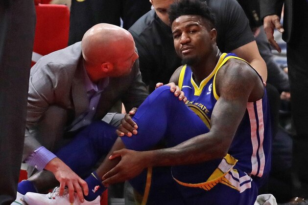 CHICAGO, IL - JANUARY 17:  Jordan Bell #2 of the Golden State Warriors is attended to after suffering a leg injury on the first play of the game against the Chicago Bulls at the United Center on January 17, 2018 in Chicago, Illinois. NOTE TO USER: User expressly acknowledges and agrees that, by downloading and or using this photograph, User is consenting to the terms and conditions of the Getty Images License Agreement.  (Photo by Jonathan Daniel/Getty Images)