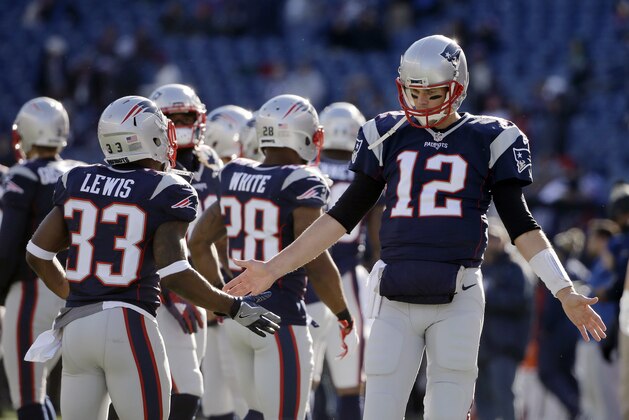 New England Patriots quarterback Tom Brady (12) slaps hands with running back Dion Lewis before an NFL football game against the Los Angeles Rams, Sunday, Dec. 4, 2016, in Foxborough, Mass. (AP Photo/Elise Amendola)