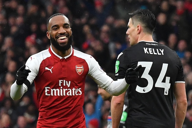 Arsenal's French striker Alexandre Lacazette (L) celebrates after scoring their fourth goal during the English Premier League football match between Arsenal and Crystal Palace at the Emirates Stadium in London on January 20, 2018.  / AFP PHOTO / Ben STANSALL / RESTRICTED TO EDITORIAL USE. No use with unauthorized audio, video, data, fixture lists, club/league logos or 'live' services. Online in-match use limited to 75 images, no video emulation. No use in betting, games or single club/league/player publications.  /         (Photo credit should read BEN STANSALL/AFP/Getty Images)