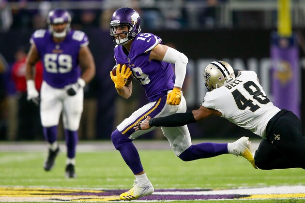 MINNEAPOLIS, MN - JANUARY 14:  Adam Thielen #19 of the Minnesota Vikings breaks a tackle from Vonn Bell #48 of the New Orleans Saints during the first half of the NFC Divisional Playoff game at U.S. Bank Stadium on January 14, 2018 in Minneapolis, Minnesota.  (Photo by Jamie Squire/Getty Images)