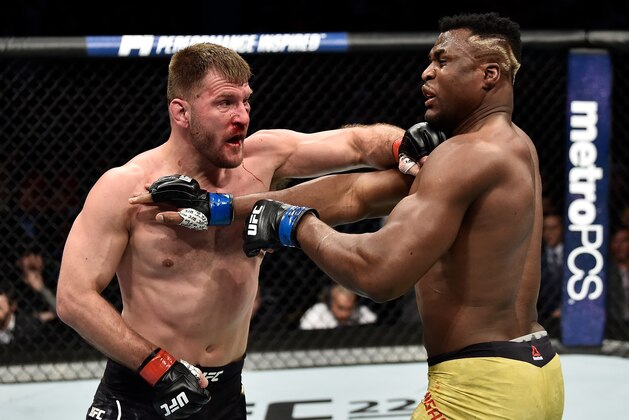 BOSTON, MA - JANUARY 20:  (L-R) Stipe Miocic punches Francis Ngannou of Cameroon in their heavyweight championship bout during the UFC 220 event at TD Garden on January 20, 2018 in Boston, Massachusetts. (Photo by Jeff Bottari/Zuffa LLC/Zuffa LLC via Getty Images)