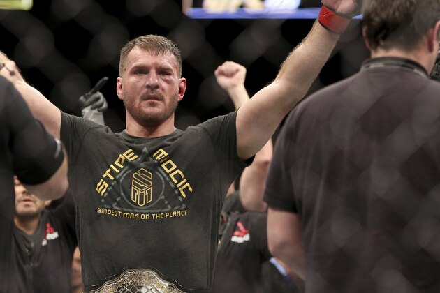 Stipe Miocic receives his belt after a win over Francis Ngannou during a heavyweight championship mixed martial arts bout at UFC 220, early Sunday, Jan. 21, 2018, in Boston. (AP Photo/Gregory Payan)